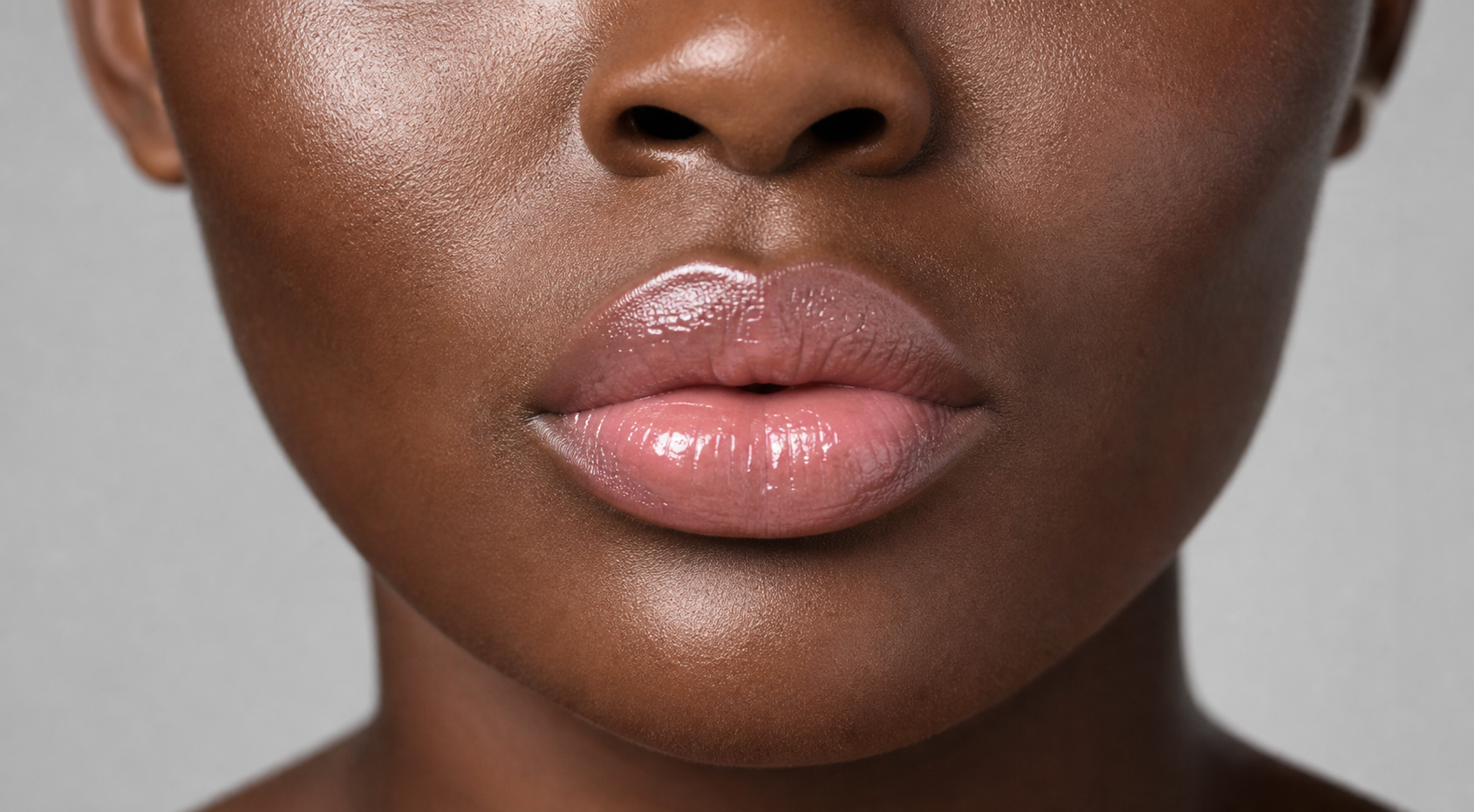 Nude Pink lip balm shade on glossy full lips